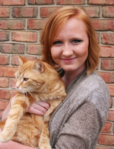 Maddie with an orange cat